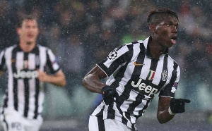 Juventus' French midfielder Paul Pogba celebrates after scoring during the UEFA Champions League Group A football match Juventus vs Olympiakos at the Juventus Stadium in Turin on November 4, 2014. AFP PHOTO / MARCO BERTORELLO (Photo credit should read MARCO BERTORELLO/AFP/Getty Images)
